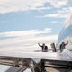 President Trump waves from the door of Air Force One.